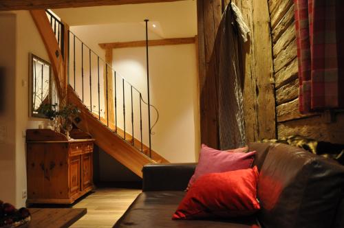 a living room with a couch and a staircase at Panorama Chalet Heimatliebe in Ladis