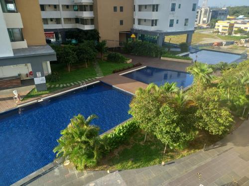 an overhead view of a swimming pool with trees and buildings at Sunset View 969 PD Waterfront in Port Dickson