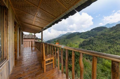 a balcony of a house with a view of the mountains at Chapa Farmstay - Mountain Retreat in Sa Pa