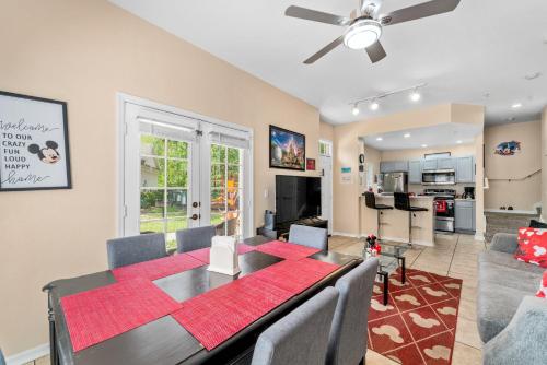 a dining room and living room with a table and chairs at Perfect for Family, Wake up Next to the pool! in Kissimmee
