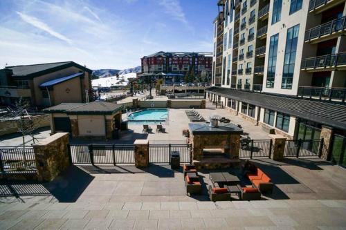 a view of a patio with a pool and buildings at Penthouse Ski-In Ski-Out Above Sheraton 1bd 1.5ba in Steamboat Springs