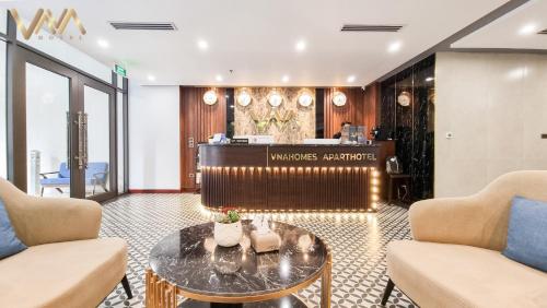 a lobby with a table and chairs and a salon at VNAHOMES Serviced Apartment in Hanoi