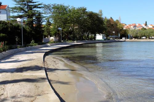 a walkway along the shore of a body of water at Apartments by the sea Kali, Ugljan - 834 in Kali