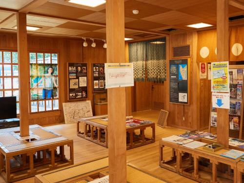 a room with tables and a sign on a pole at ミチ旅ホテル 読谷 in Yomitan