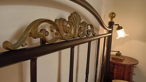 a spiral staircase with a gold railing and a lamp at Atheaton Traditional Guest Ηouse Nafplion in Nafplio