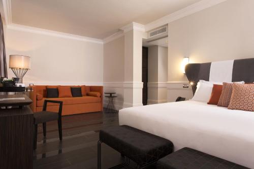 a bedroom with a bed and a living room at Palazzo Navona Hotel in Rome