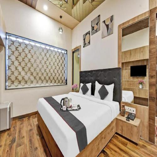 a bedroom with a large bed and a window at Hotel Shakun Palace in Kota