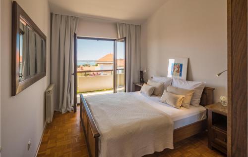 a bedroom with a large bed and a large window at Awesome Apartment In Medulin With Outdoor Swimming Pool in Medulin
