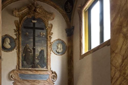 an ornate clock on a wall with a window at Hotel Garibaldi Blu - WTB Hotels in Florence