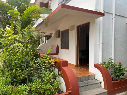 a house with stairs and plants in front of it at Lifestyle villa in Candolim