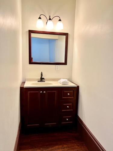 a bathroom with a sink and a mirror at The Monarch Hotel in Port Townsend