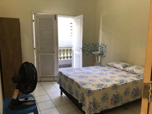 a bedroom with a bed and a door to a balcony at Bela Vista in São Luís