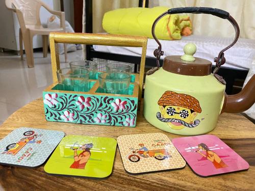 a table with a tea kettle and some cards on it at Jawai Bagpackers Hostel in Sheoganj