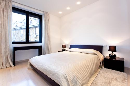 a bedroom with a bed and a large window at Homeinmilano Duomo in Milan