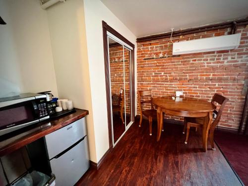 a dining room with a table and a brick wall at The Monarch Hotel in Port Townsend
