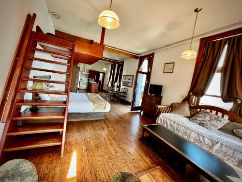 a bedroom with two bunk beds and a living room at The Monarch Hotel in Port Townsend