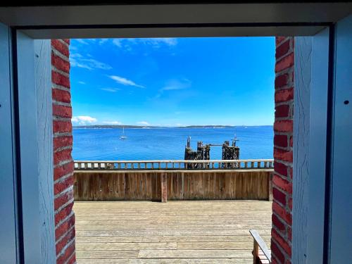 a window view of the ocean from a balcony at The Monarch Hotel in Port Townsend
