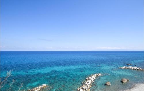 a view of the ocean with rocks and blue water at Amazing Home In Belmonte Calabro in Belmonte Calabro