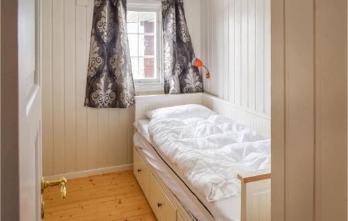 a bed in a corner of a room with a window at Stunning Home In Sjusjen With House A Mountain View in Sjusjøen