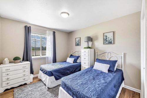 a bedroom with two beds and a window at Serene 3 Bedroom Home, NRM, Wi-fi, Parking, Queen Bed in De Pere