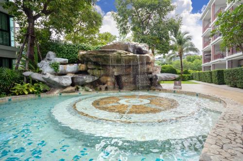 a fountain in the middle of a swimming pool at The Title Rawai Beach West Wing Pool Access Aparment in Rawai Beach