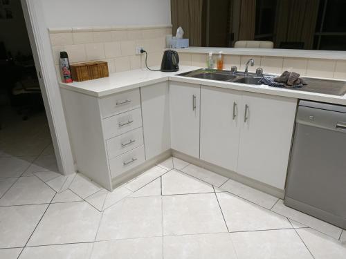a white kitchen with a sink and a dishwasher at Golden Retreat in Golden Grove