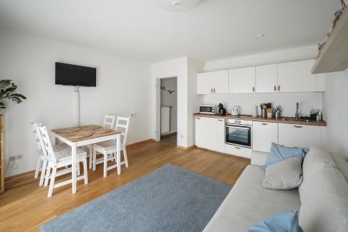 a living room and kitchen with a couch and a table at Ferienwohnung Lieblingsplatz in Traunstein