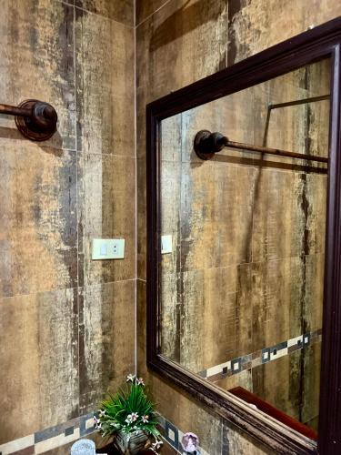 a bathroom with a mirror on a wall at Siridel Luang Prabang in Luang Prabang