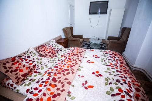 - une chambre avec un lit et une couette à fleurs dans l'établissement Belle chambre sur liège, à Liège