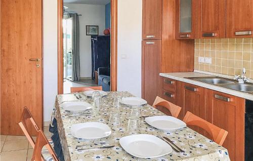 a kitchen with a table with white plates on it at Casa Chappell in Badolato