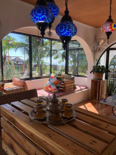 a dining room with a table and blue lights at Vistapaloma beach resort in Odiong