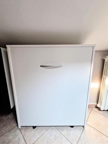 a white cabinet with a drawer in a room at Beinasco Apartment - Le Terrazze Palace in Beinasco