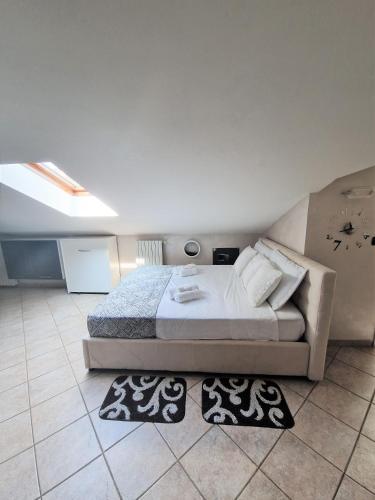 a bedroom with a bed and two rugs on the floor at Beinasco Apartment - Le Terrazze Palace in Beinasco