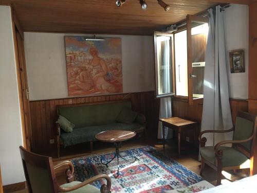 a living room with a couch and a table at Chalet Nicouski in La Salle Les Alpes