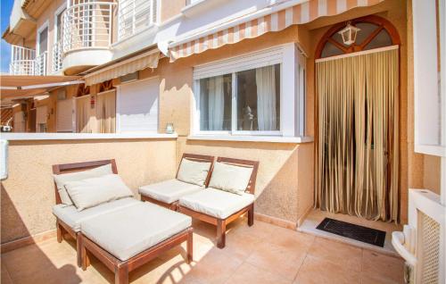 a couple of chairs sitting on a balcony at 2 Bedroom Lovely Home In Santa Pola in Santa Pola