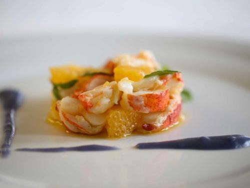 a piece of food with shrimp and vegetables on a plate at Le Muse Hotel in San Bonifacio