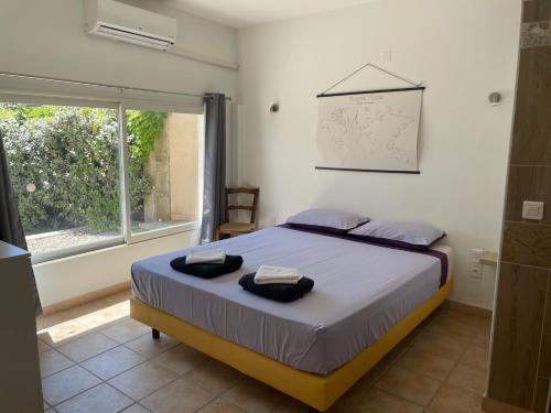 une chambre avec un lit avec deux serviettes dessus dans l'établissement Les Célestins - Villa en Provence, à Carpentras