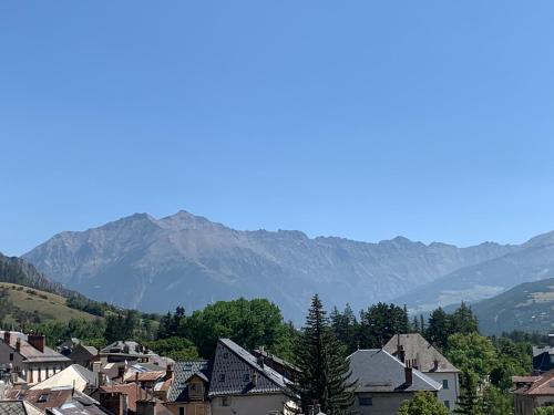 a small town with mountains in the background at Studio neuf in Barcelonnette