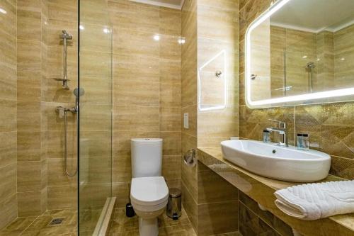a bathroom with a toilet and a sink and a shower at OneTime Hotel in Anapa