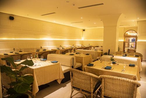 a restaurant with tables and chairs in a room at Jagadish Hotels Sankey Road in Bangalore