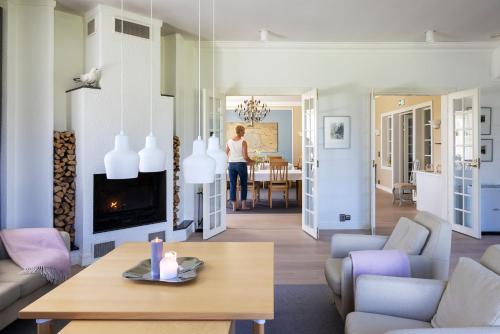 a woman is standing in a living room at House of Northern Senses in Ruka