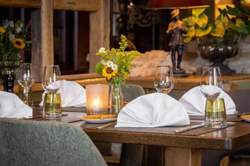 a wooden table with glasses and napkins on it at Waldhaus Reinbek in Reinbek