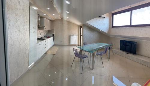 a kitchen with a table and chairs in a room at Casa vacanze rosario in Vena Superiore