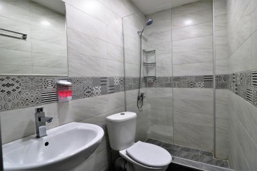 a bathroom with a toilet and a sink and a shower at Hotel Rose in Tbilisi City
