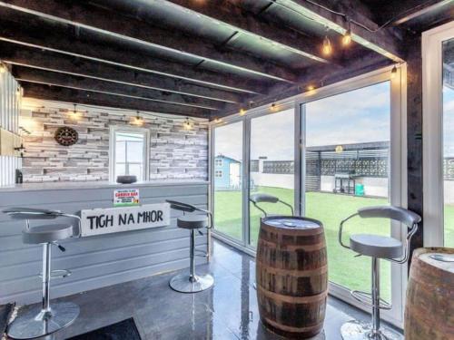 a bar with two stools and a barrel at Tigh Na Mhor , Hot Tub , Games Room , 5 Bedroom ,Sleeps 13 , Large Villa in Cruden Bay