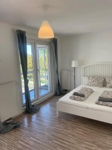 a bedroom with a bed and a large window at Vienna City Apartment 1230 Vienna in Vienna