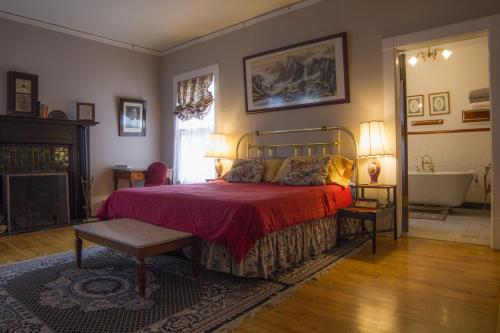 a bedroom with a bed and a tub in it at Lehmann House Bed & Breakfast in Saint Louis