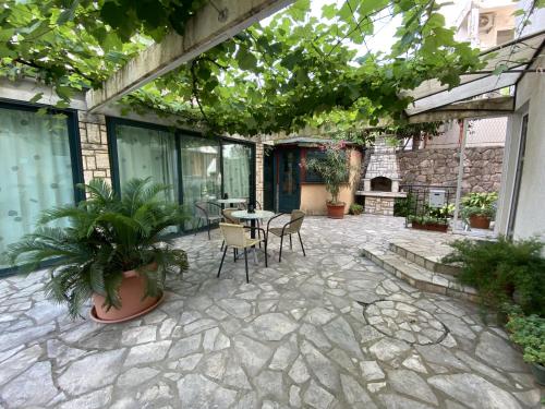 a patio with a table and chairs and plants at Alina's apartment in Becici