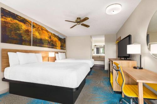 a hotel room with a bed and a desk at Days Inn by Wyndham Demopolis in Demopolis