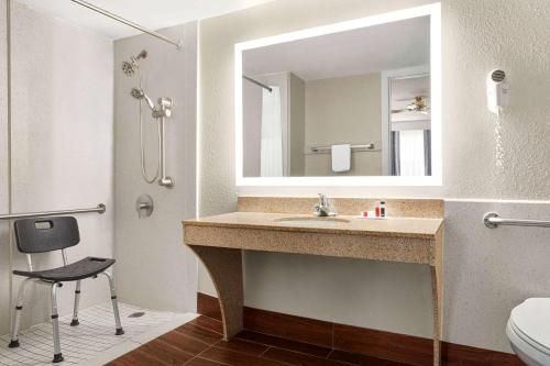 a bathroom with a sink and a mirror at Days Inn by Wyndham Demopolis in Demopolis